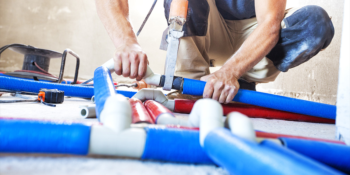 Man connecting pipes.