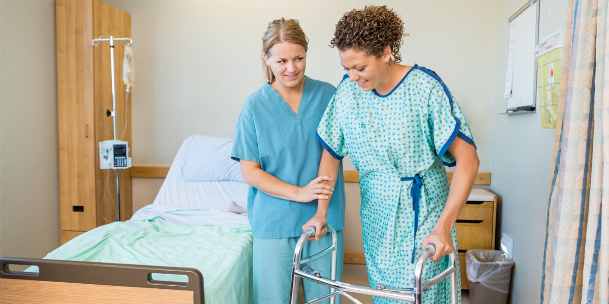 Nurse assistant helping patient