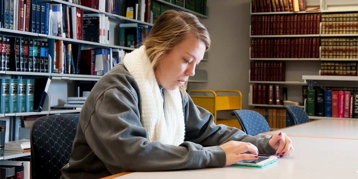 AACC student reading in law library.