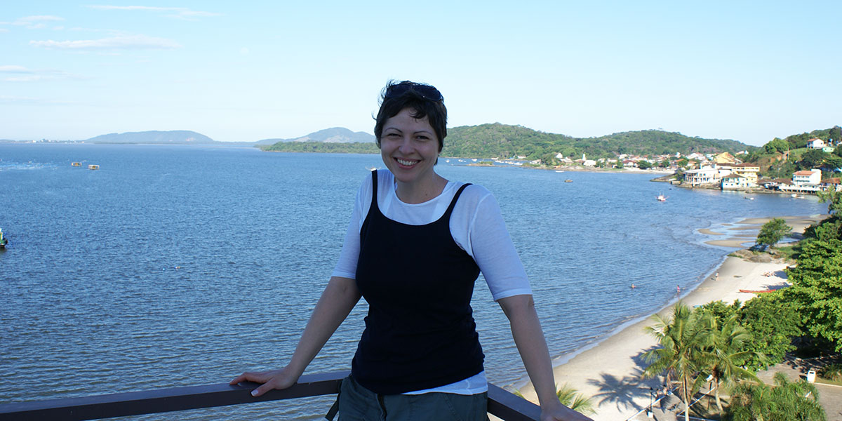 Grace Sikorski smiling with a beach in the background