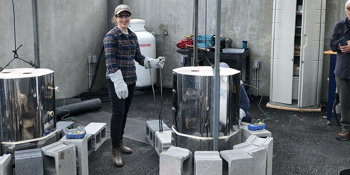 Sara Prigodich working at a raku kiln