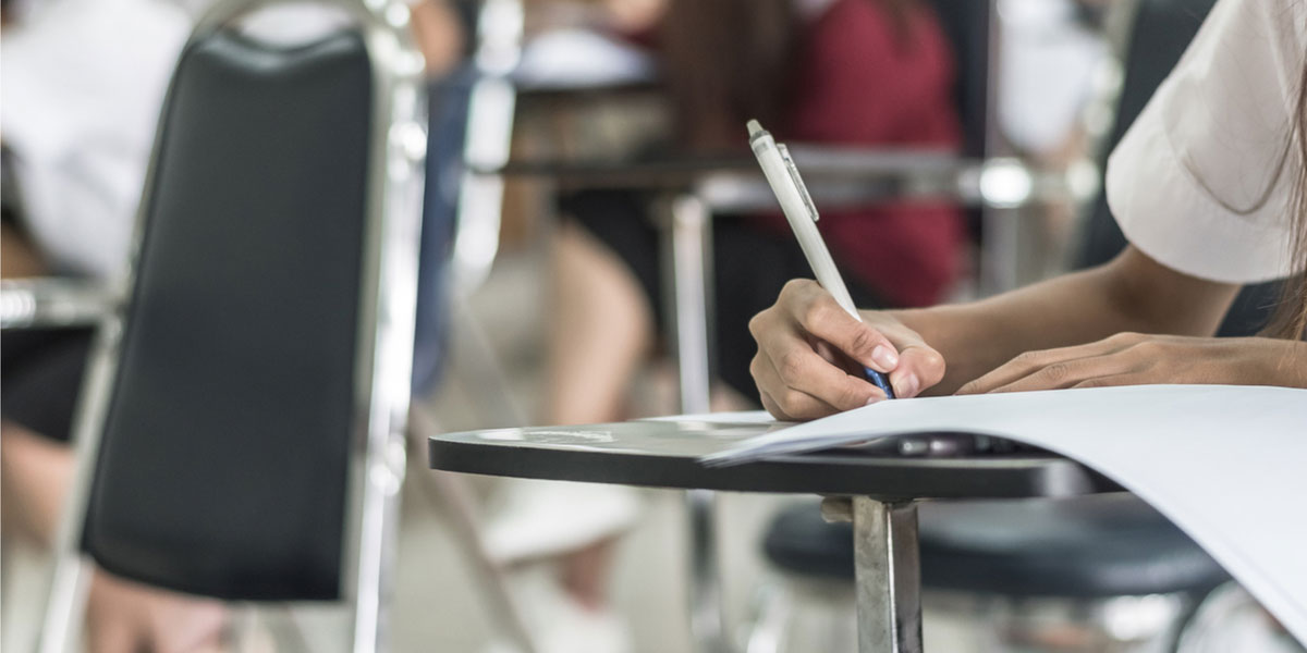 Student writes at her desk.