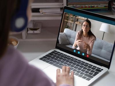 Student talks with faculty via video conference.